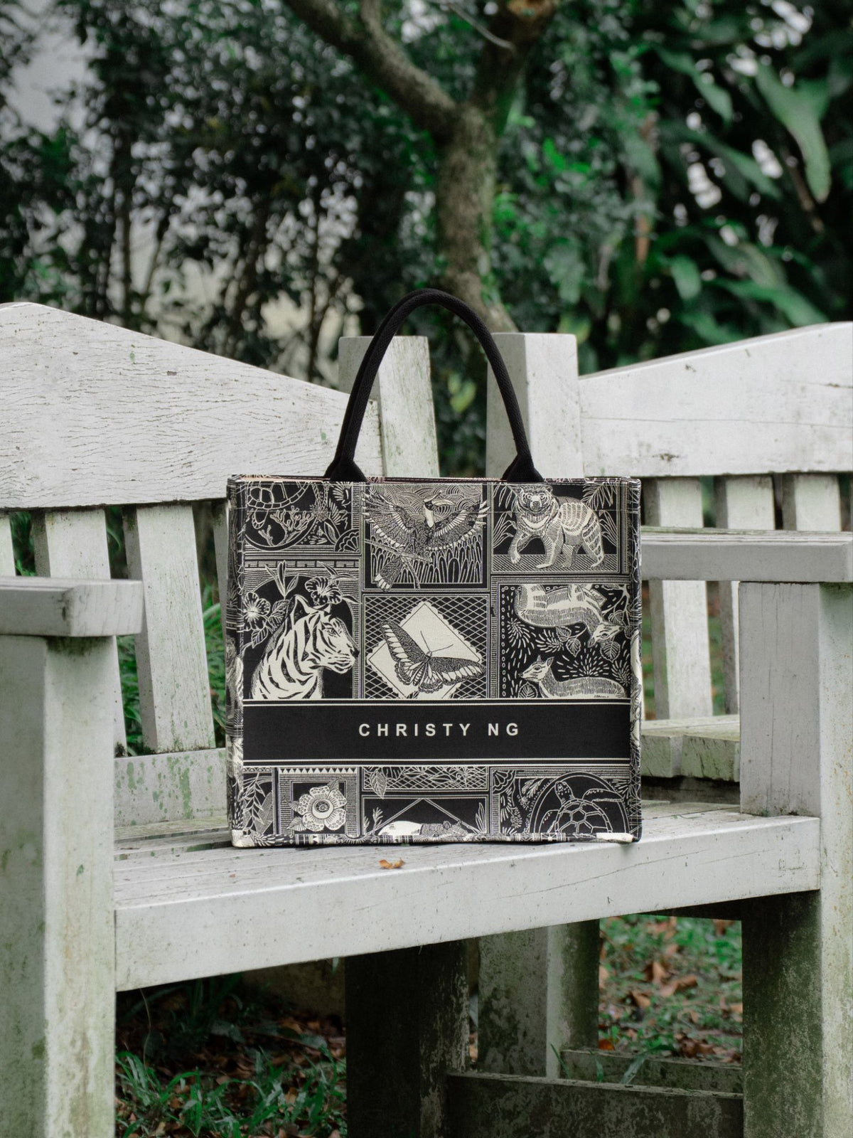 Christy Ng Malaya Grocery Tote on a garden bench
