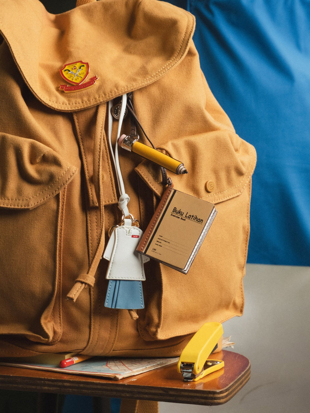 Merdeka charms clipped onto a school backpack