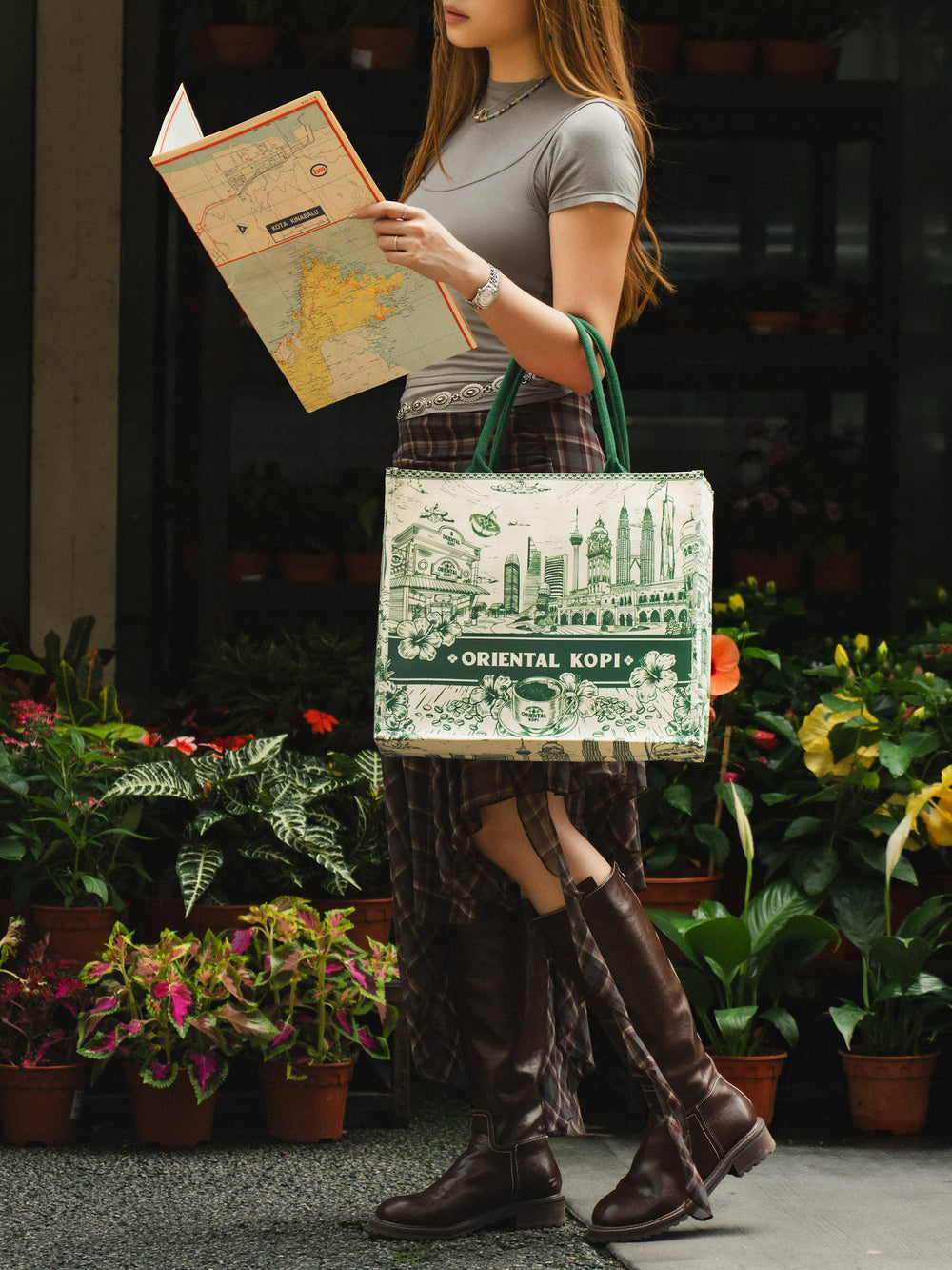 Model with the Christy Ng x Oriental Kopi tote outside a flower shop